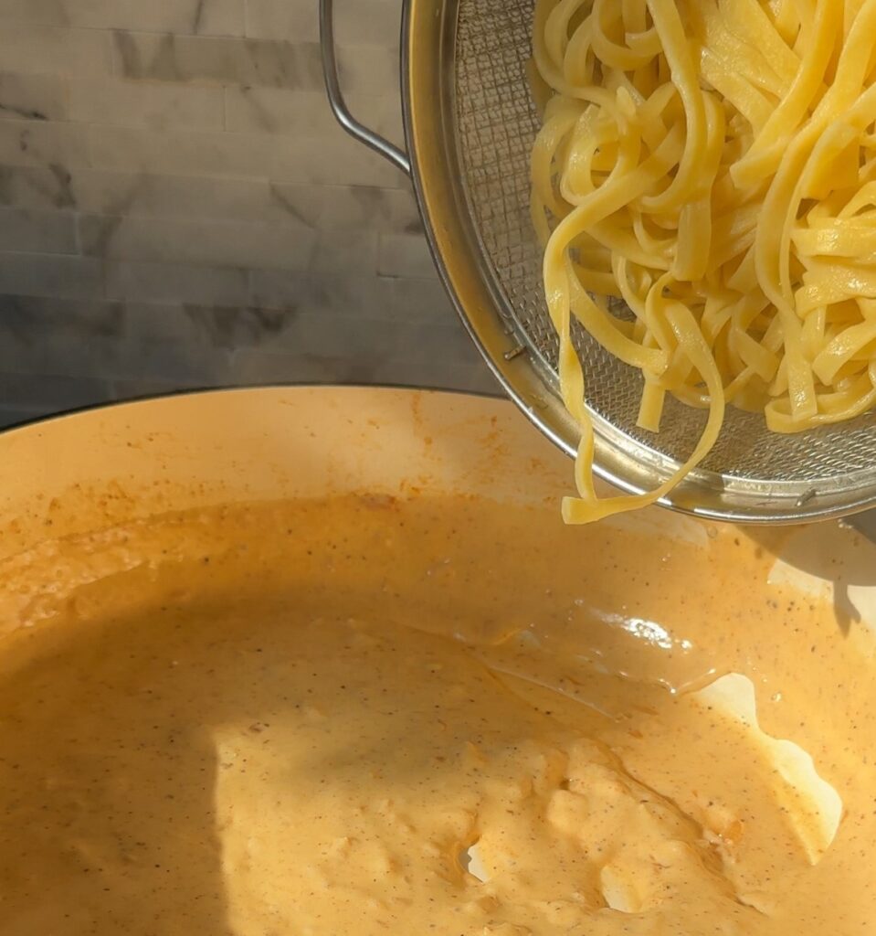 Stir in fettuccine pasta to the sauce
